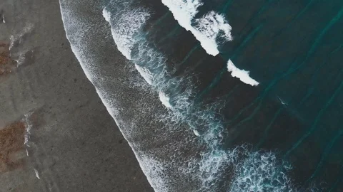Top view of transition between sandy beach and turquoise sea with waves, Bali Stock Footage 140279445