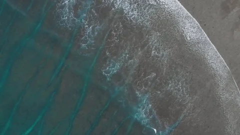 Top view of transition between sandy beach and turquoise sea with waves, Bali Stock Footage 140279548