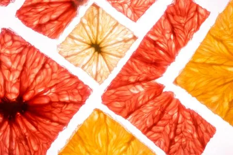 Top view of transparency square slices of fresh citrus fruits grapefruit lime Stock Photos