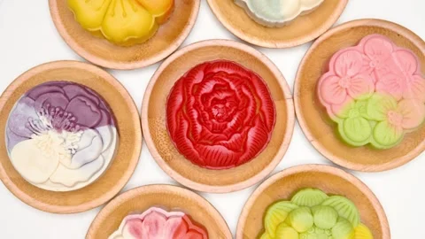 Top view trendy different flower shapes mooncakes rotating at horizontal Stock Footage 248596912