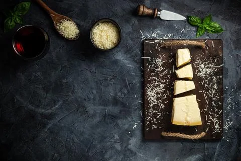 Top view of triangular piece of hard cheese on wooden cutting board Stock Photos