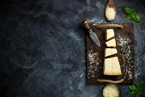 Top view of triangular piece of hard cheese on wooden cutting board Stock Photos