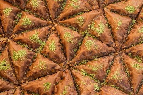 Top view of triangular-shaped chocolate baklava with pistachio toppings 库存照片