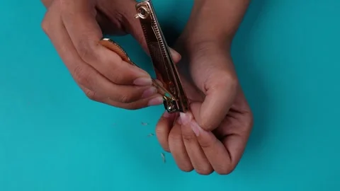 Top view trimming fingernails isolated blue background Stock Footage 275885869