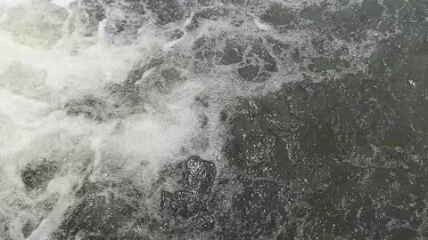 Top view of turbulent river water creating white foam bubbles Stock Footage 346766325