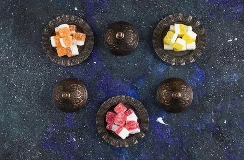 Top view of Turkish tea set. Fragrant tea and sweet candies on blue background Stock Photos