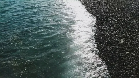 Top view on turquoise ocean waves softly breaking against the coastal line Stock Footage 95716399