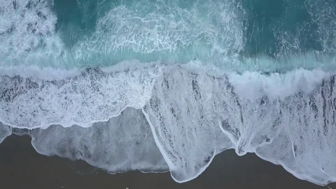 Top view turquoise waves break on empty beach. Clean ocean waves reaching shore Stock Footage 109659354