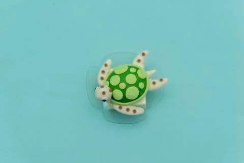 Top view of turtle shapes personalized candy on a green turquoise background. Stock Photos