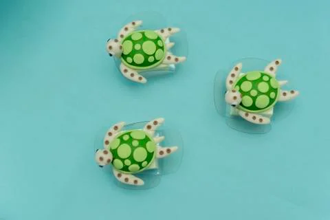 Top view of turtle shapes personalized candy on a green turquoise background. Stock Photos