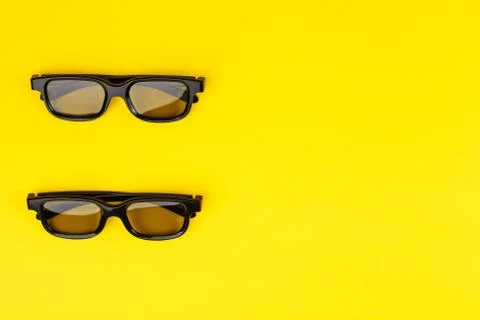 Top view of two 3D glasses on a yellow background 스톡 사진