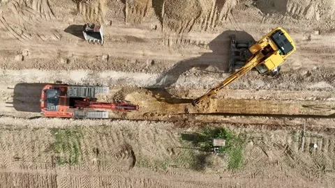 Top view of two backhoes working together excavating a trench Stock Footage 285825975