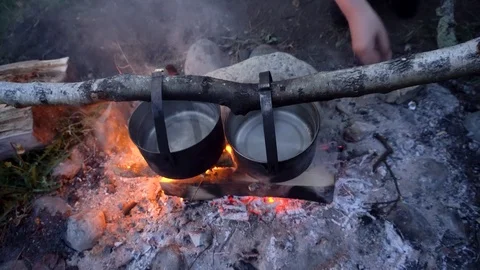 Top view of two boilers above the campfire for cooking at the campsite. Stock Footage 120491089