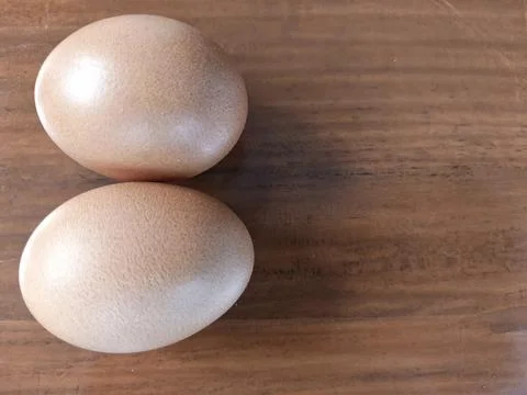Top View of Two Brown Chicken Eggs on Wooden Table Background Stock Photos