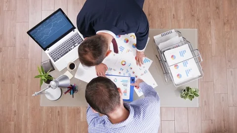 Top view of two businessman checking charts from different files Stock Footage 114903262