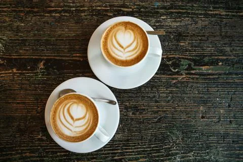 Top view. Two cups of fragrant delicious cappuccino coffee with foam and a Stock Photos