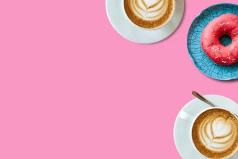 Top view. Two cups of fragrant delicious coffee cappuccino and a number of donut Stock Photos