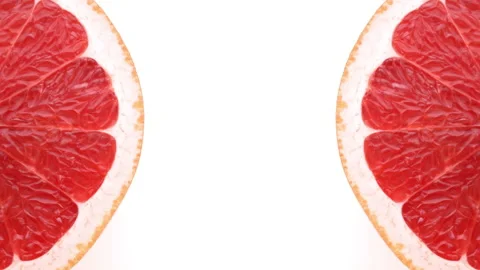 Top view of two grapefruit halves rotating on white background. Top view. Stock-Footage 158540407
