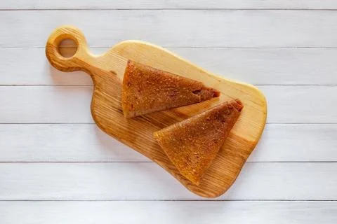 Top view of two light brown triangular fruit pastille pieces placed on wood.. Stock Photos