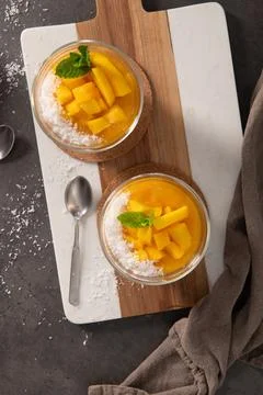 Top View of Two Mango Chia Seed Puddings Garnished with Fresh Fruit and Cocon Stock Photos