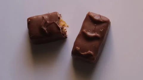 Top view of two milk chocolate bars with caramel filling on a plain surface Stockbeeldmateriaal 329615561