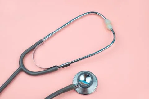 Top view of two part of one single stethoscope isolated on a pink colored bac Stock Photos