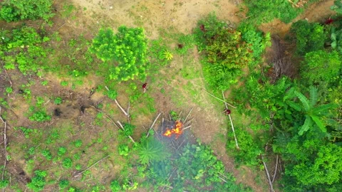 Top view of two people around a large fire Stock Footage 143035691