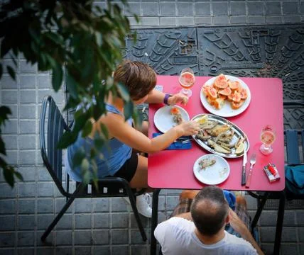 Top view of two people eating typical Spanish dishes Stock Photos
