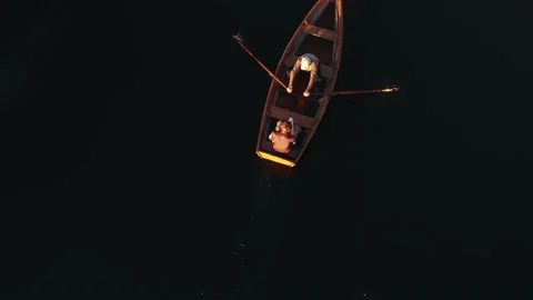 Top view two people ride small rowing boat on idyllic still lake enjoying Stock Footage 152474856