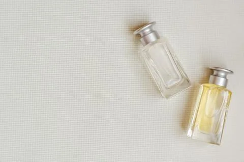Top view of two perfume bottles with caps. Refinement and perfumery. Selectiv Stock Photos