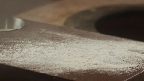 Top view of two pieces of dough falling on table with flour. Slow motion video Stock Footage 124732080