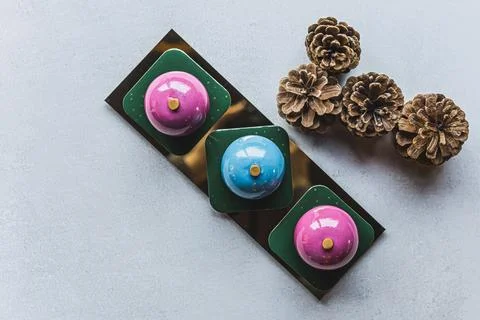 Top view of two pink and one blue cake placed in line next to each other on a Stock Photos