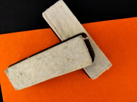 Top view of two plastic black board duster with white material pad on orange  Stock Photos