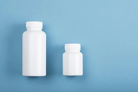 Top view two plastic white bottles on blue background Stock Photos