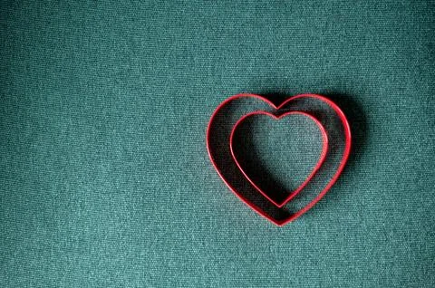 Top view of two red hearts on green background with copy space. Stock Photos