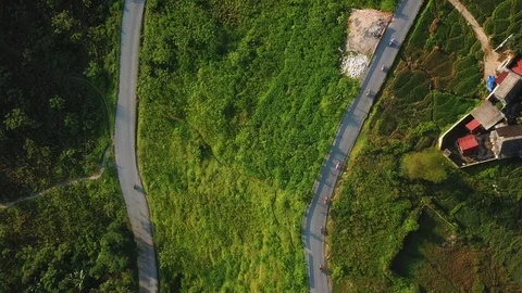 Top-view of two split roads of motorcycles riding on a paved road through Stock Footage 106118578
