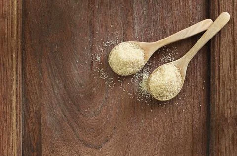 Top view two spoons of brown sweet  sugar  on wooden table with copy space. Fotos de archivo