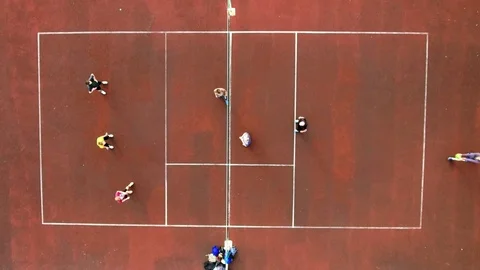 Top view of two teams playing volleyball on the court outdoors, jumping and Stock Footage 76681635