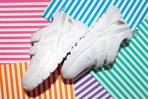 Top view two white kid sneakers with velcro fasteners for comfortable footwea Stock Photos