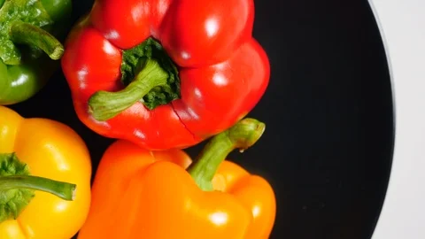 Top View Of Uncooked Fresh Raw Yellow, Red, Green, Orange Bell Peppers Rotating  Stock Footage 124860018