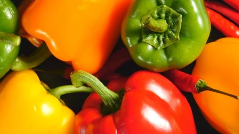 Top View Of Uncooked Fresh Raw Yellow, Red, Green, Orange Bell Peppers And Red C Stock Footage 128597626