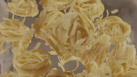 Top view uncooked noodle nest flying up. Slow motion video Stock Footage 114307580
