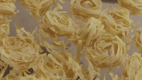 Top view uncooked noodle nest in slow motion toss up Stock Footage 114307610