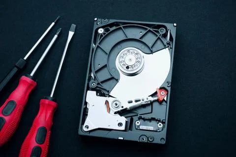 Top view uncovered hard drive and screwdrivers, Computer hardware inspection Fotos Stock