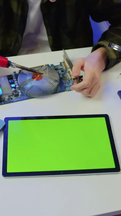 Top view. Unknown male hands using green screen tablet und soldering microcircui Stock Footage 327817505