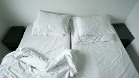 Top view of unmade double beds after wake up in the morning Stock Footage 153508128