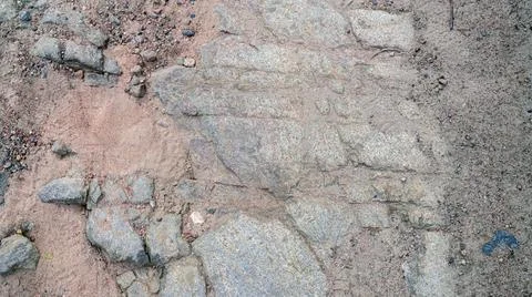 Top view unpaved road surface, stones and sand. Stock Photos