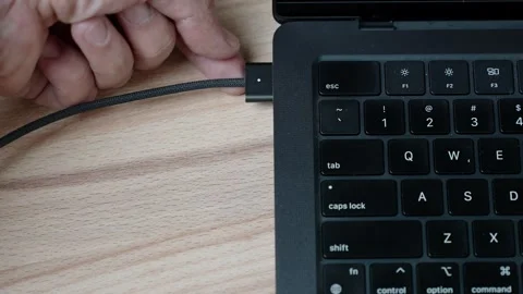 Top view of unplugging connector from portable computer Stock Footage 329625027
