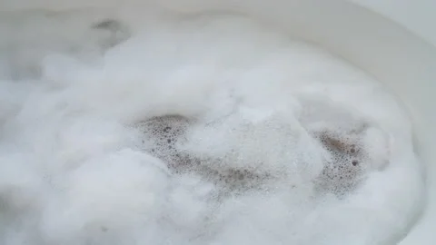 Top view of unrecognizable African woman's legs in bubble bath. Slim legs Stock Footage 138559782