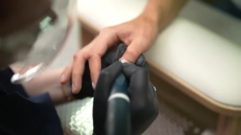 Top view of unrecognizable male customer in beauty salon having cuticles removed Stock Footage 289529472